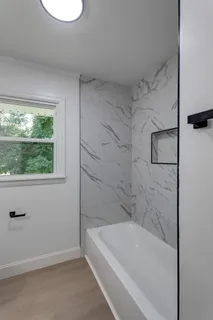 a bathroom with a bathtub and window