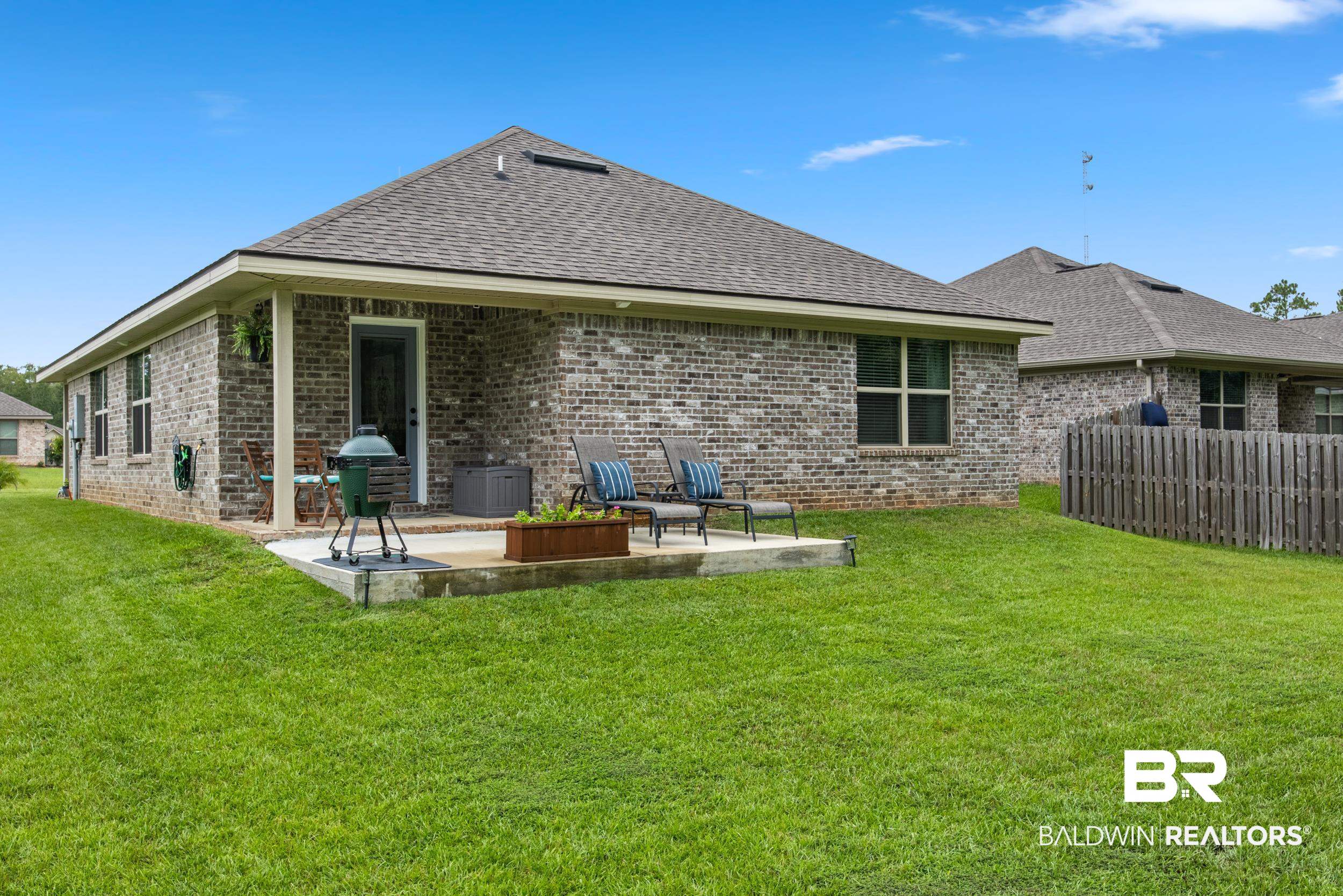3852 Chesterfield Lane Foley, AL 36535 - Photo 6 of 34 Rear view of house with a yard and a patio area