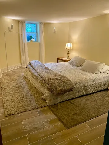 a bedroom with a bed and a mirror