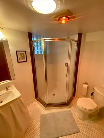 a bathroom with a sink mirror vanity and toilet