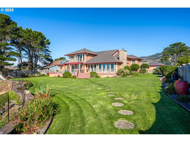 an aerial view of a house with garden space and street view