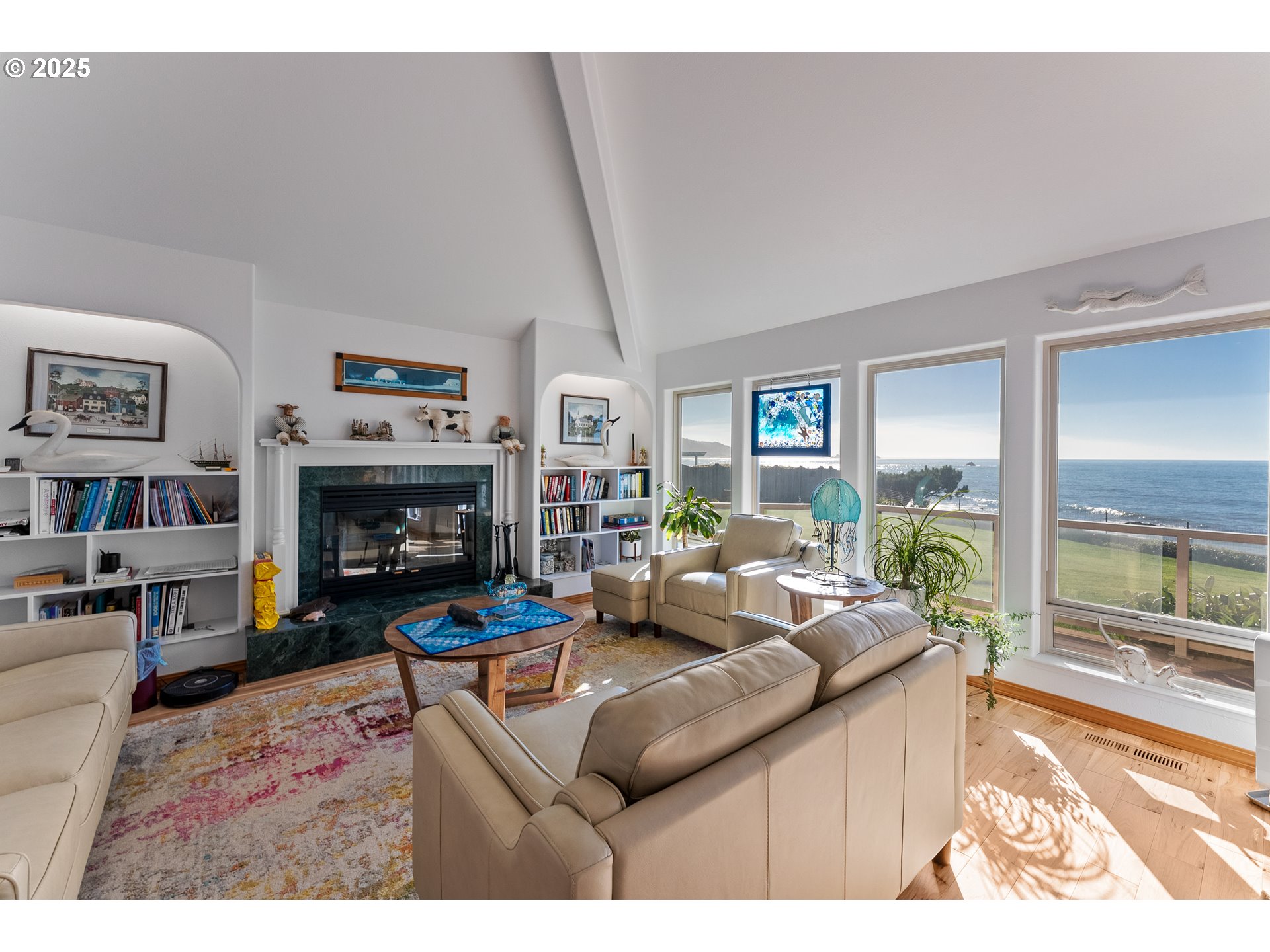 98686 Fox Drive Brookings, OR 97415 - Photo 23 of 48 a living room with furniture a fireplace and a floor to ceiling window