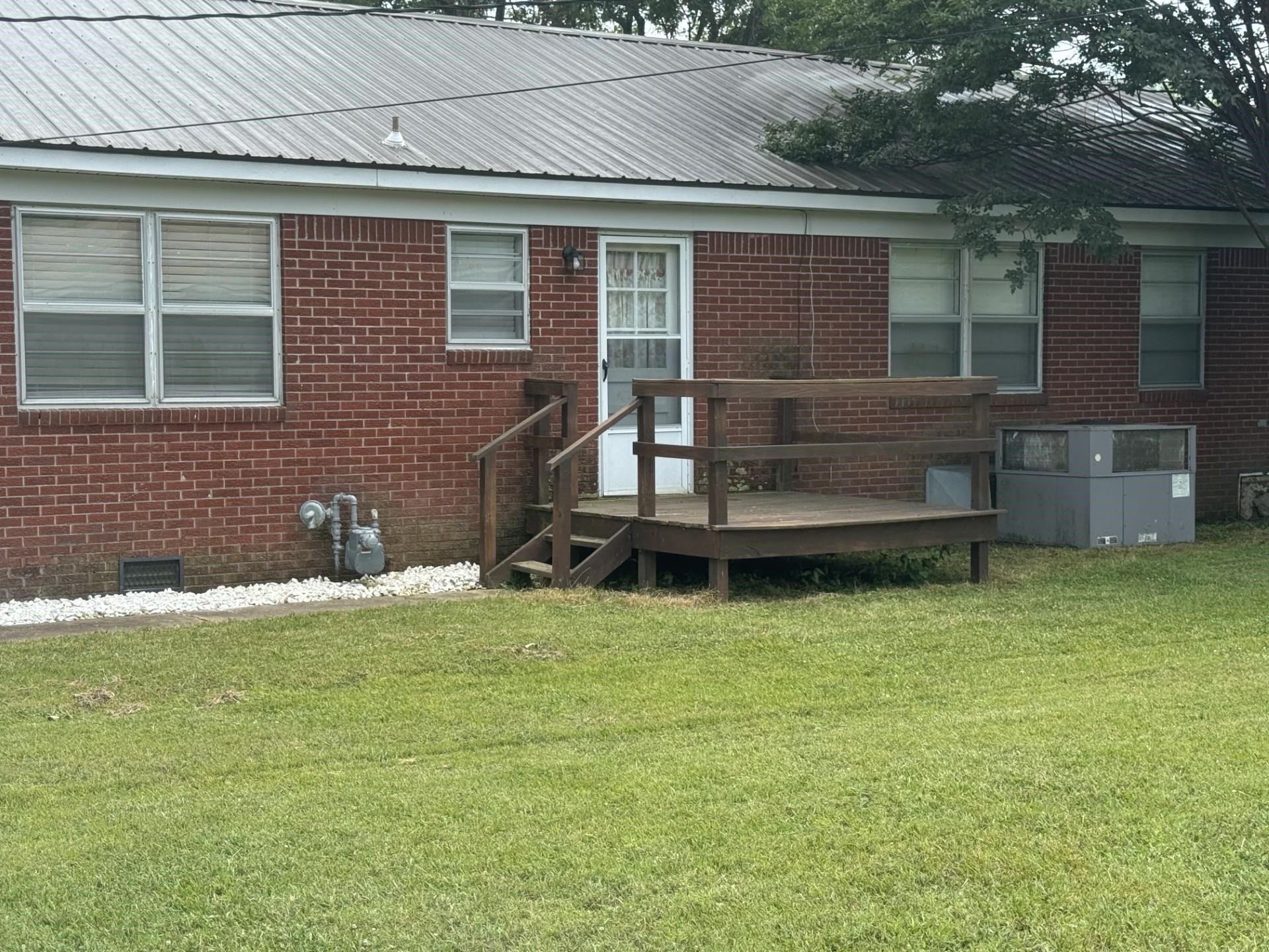 2631 Highway 51 Ripley, TN 38063 - Photo 15 of 17 Rear view of property featuring crawl space, brick , a yard, and a deck