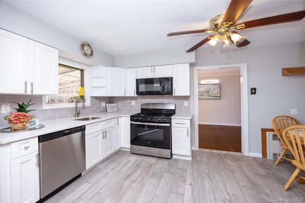 a kitchen with a stove a sink and a microwave