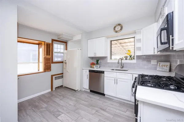 a kitchen with a sink a stove and cabinets