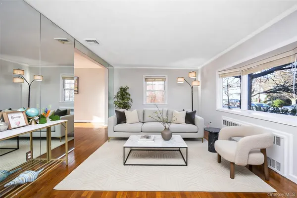 a living room with furniture rug and window