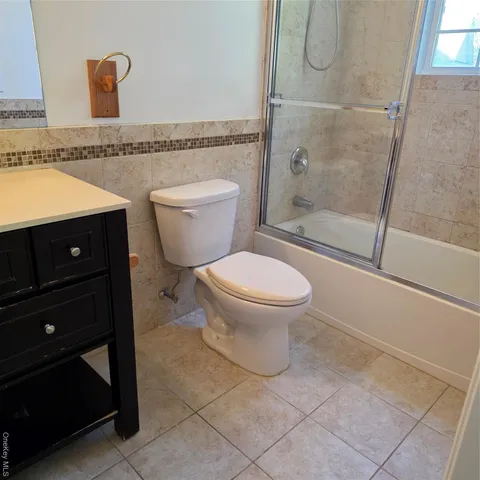 a bathroom with a toilet a sink and shower