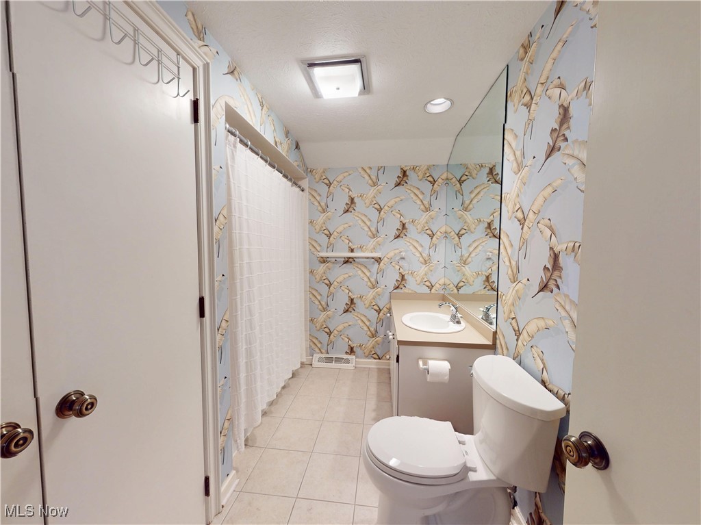 9870 Hobart Road Willoughby, OH 44094 - Photo 41 of 50 Full bathroom with vanity, toilet, tile patterned floors, wallpapered walls, and curtained shower