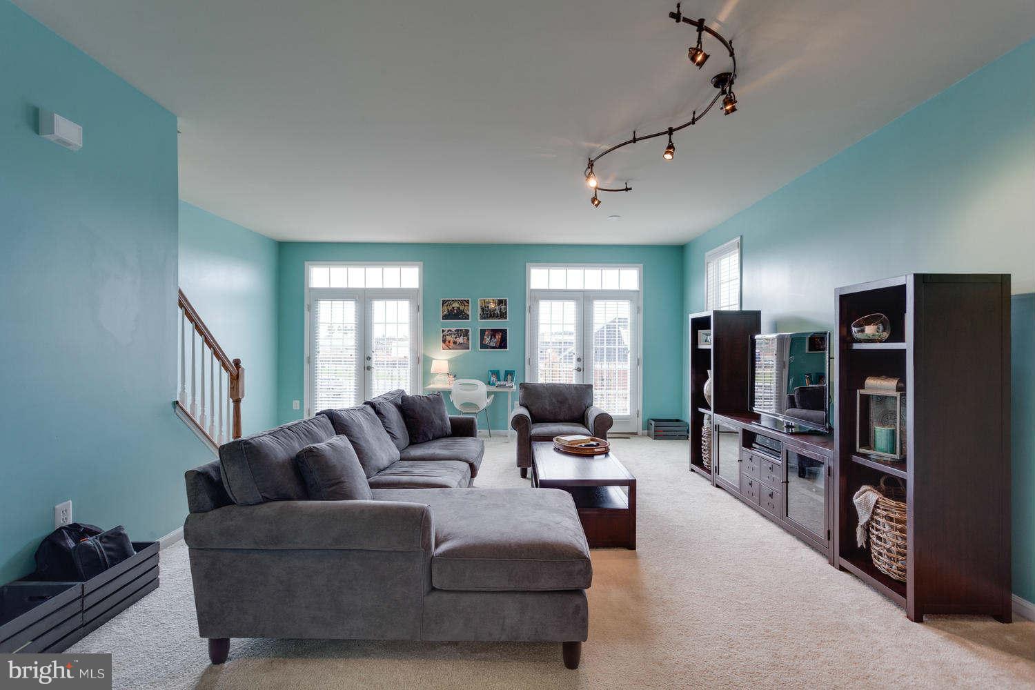 42724 Redpath Terrace Ashburn, VA 20147 - Photo 2 of 17 a living room with furniture a large window and stainless steel appliances