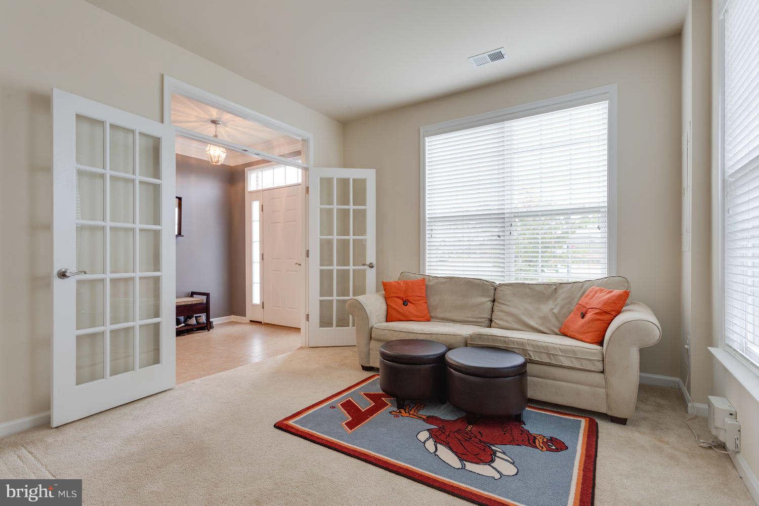 42724 Redpath Terrace Ashburn, VA 20147 - Photo 7 of 17 a living room with furniture a rug and a window