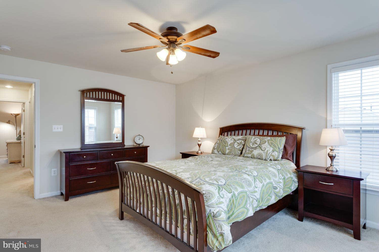 42724 Redpath Terrace Ashburn, VA 20147 - Photo 9 of 17 a bedroom with a bed and a chandelier