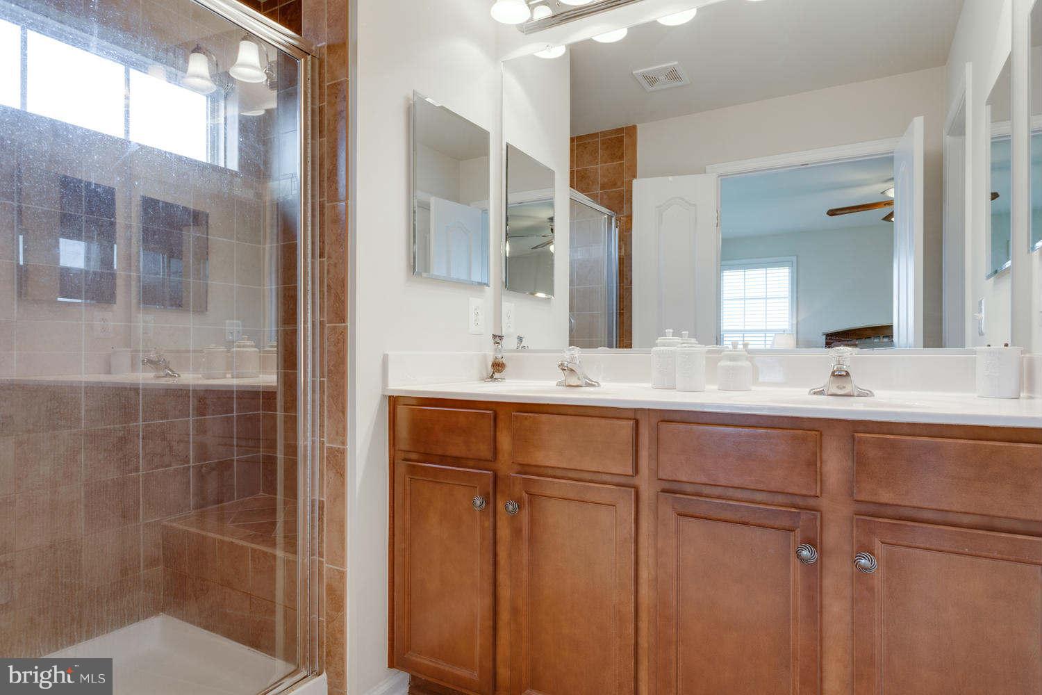 42724 Redpath Terrace Ashburn, VA 20147 - Photo 10 of 17 a bathroom with double vanity sink and a mirror