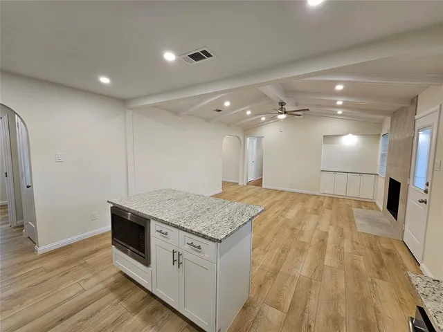 a kitchen with a sink and a mirror