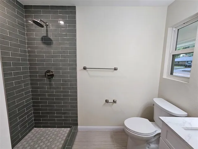 a bathroom with a toilet and a shower