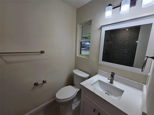 a bathroom with a sink toilet and mirror