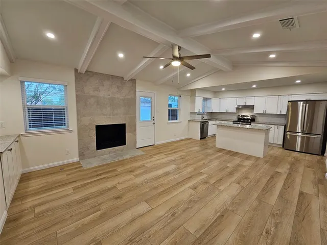 a view of kitchen with cabinets and wooden floor