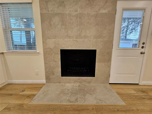 a living room with a fireplace and a rug