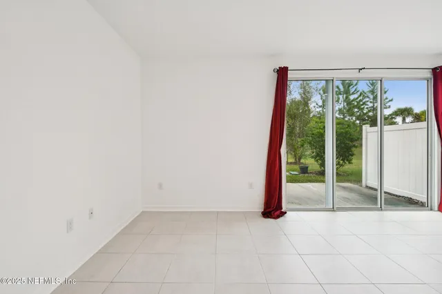a view of empty room with floor to ceiling window