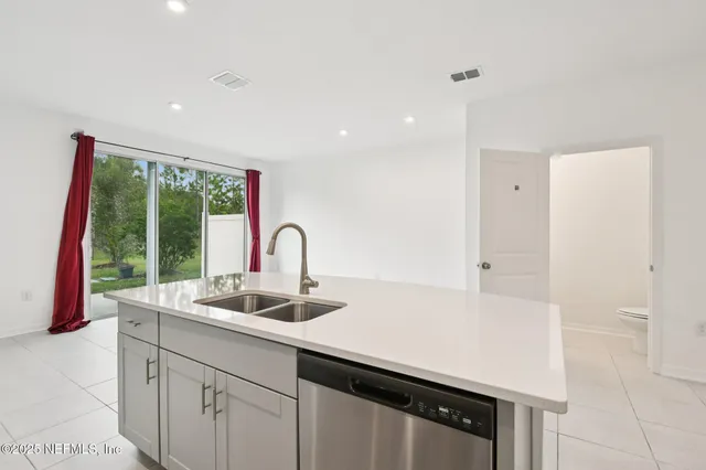 a kitchen with a sink and large window
