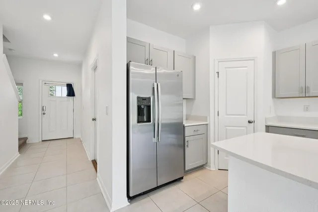 a kitchen with stainless steel appliances a refrigerator and a sink