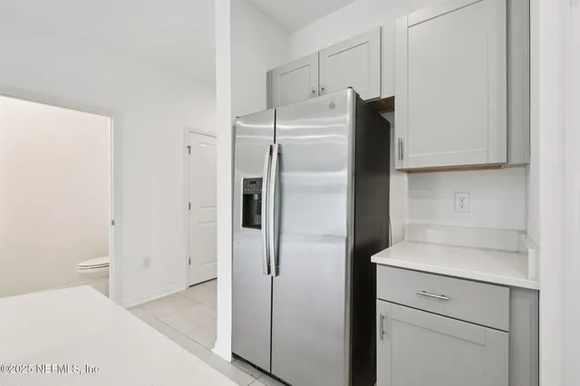 a kitchen with a refrigerator and cabinets
