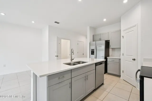 a kitchen with a sink and refrigerator