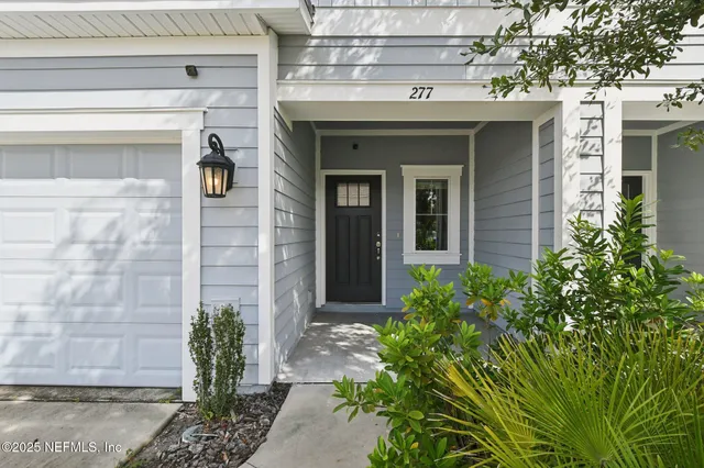 a view of a stone house with potted plants