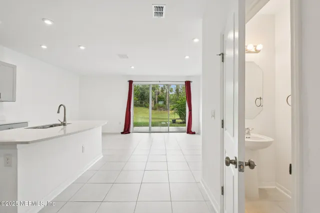 a bathroom with a granite countertop sink a mirror and a bathtub