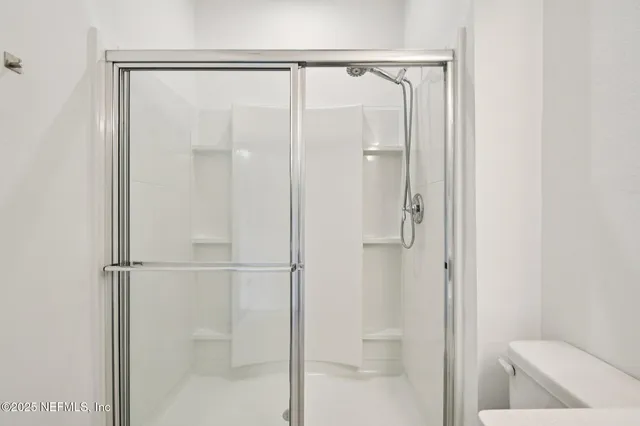 a bathroom with a glass shower door