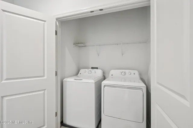 a view of storage and utility room with washer and dryer