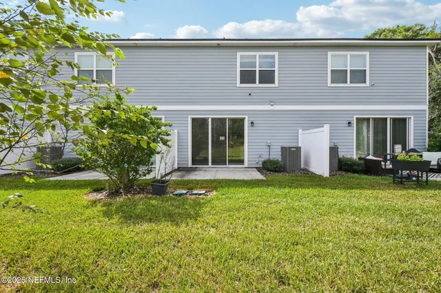 a view of a house with a yard and sitting area