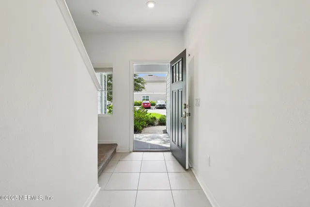 a view of a hallway to a livingroom with furniture
