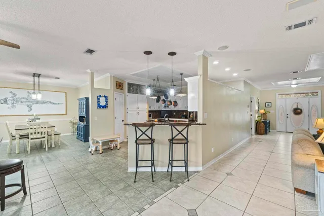 a kitchen with stainless steel appliances kitchen island granite countertop a refrigerator and a sink