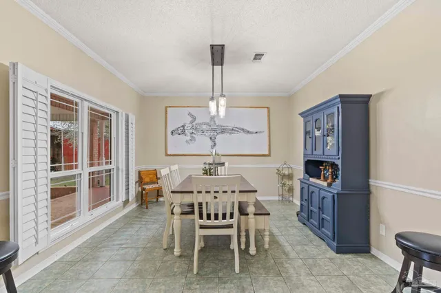 a dining room with furniture and window