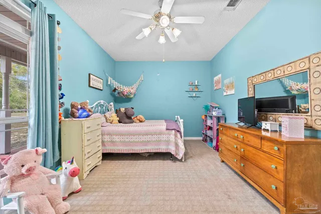 a bedroom with furniture and a flat screen tv