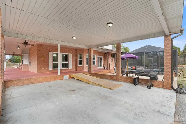 a view of a house with backyard and trees
