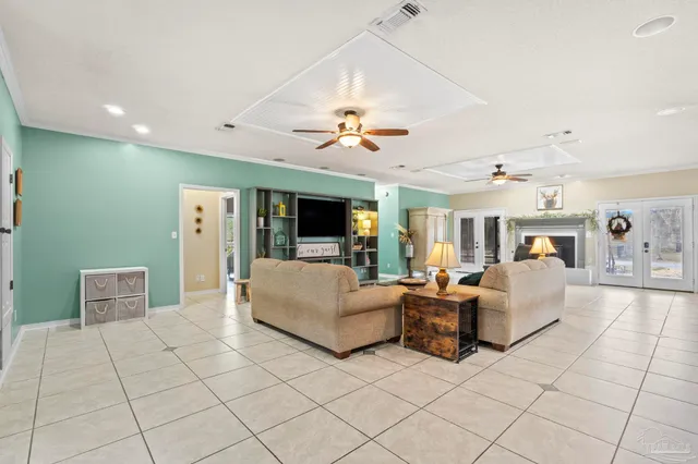 a living room with furniture and a chandelier