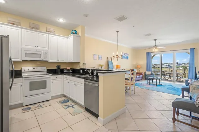 a kitchen with a stove a refrigerator and cabinets