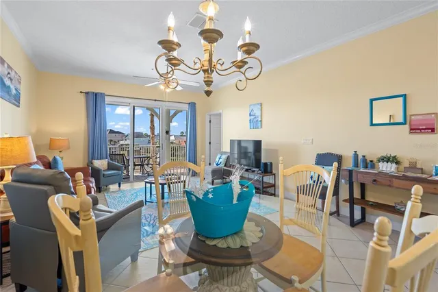 a view of a balcony with chairs and iron fence