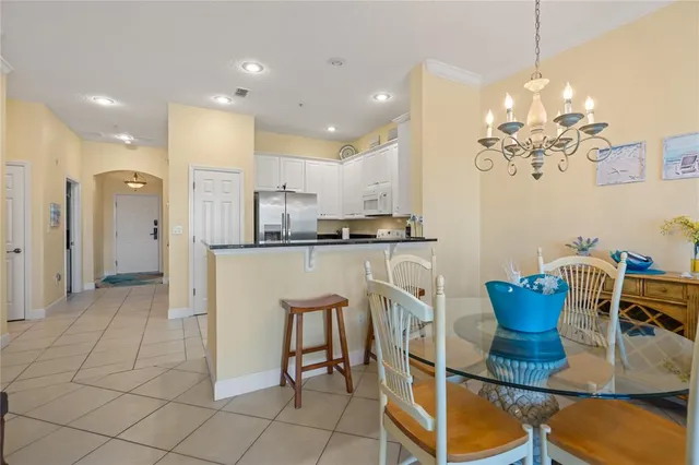 a living room with furniture kitchen view and a table