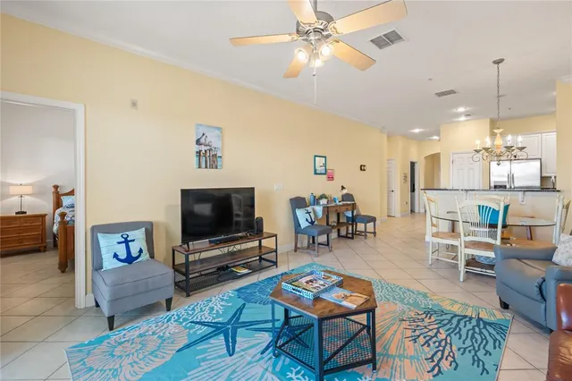 a bedroom with bed and a chandelier