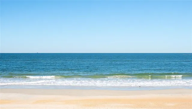 a view of a swimming pool with outdoor seating