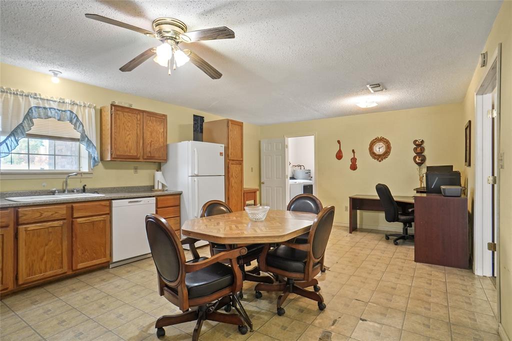 1092 West Highway 199 Springtown, TX 76082 - Photo 11 of 23 a view of a dining room with furniture and a chandelier