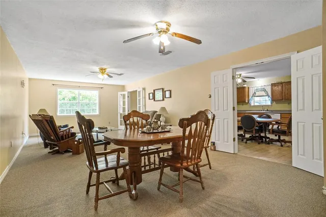 a view of a dining room with furniture and a chandelier