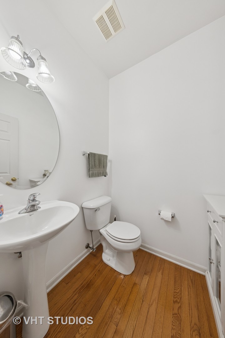 13733 Meadow Lane Plainfield, IL 60544 - Photo 13 of 39 a bathroom with a toilet a sink and mirror