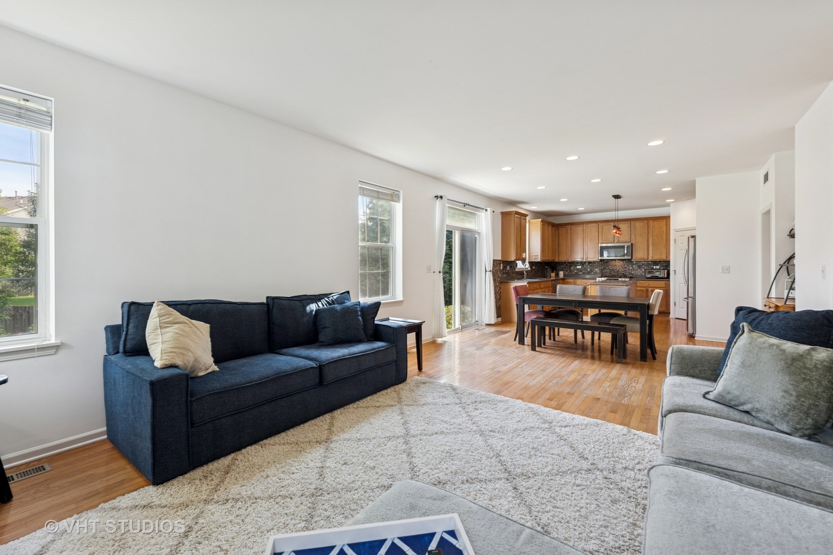 13733 Meadow Lane Plainfield, IL 60544 - Photo 2 of 39 a living room with furniture and kitchen view