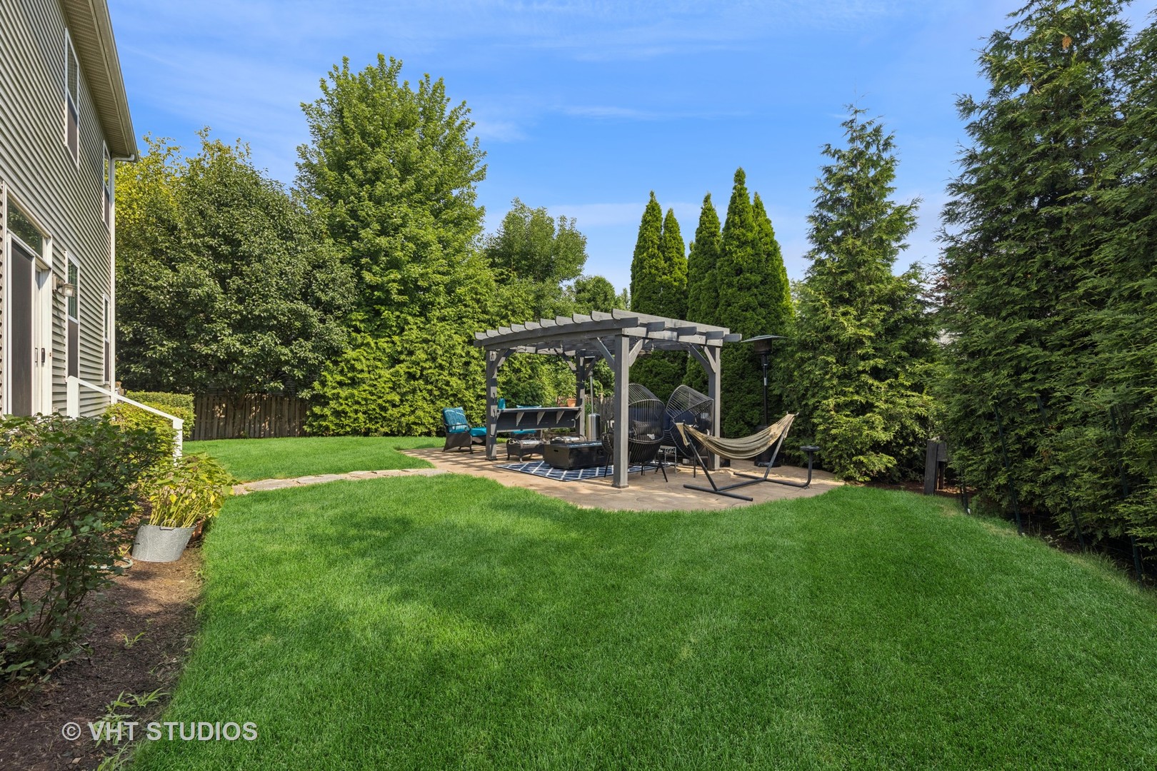 13733 Meadow Lane Plainfield, IL 60544 - Photo 32 of 39 a view of a table and chairs under an umbrella