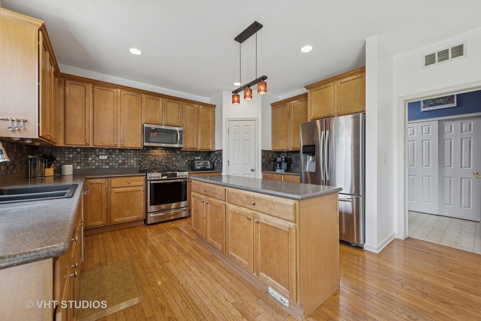 13733 Meadow Lane Plainfield, IL 60544 - Photo 5 of 39 a kitchen with stainless steel appliances a refrigerator sink and microwave