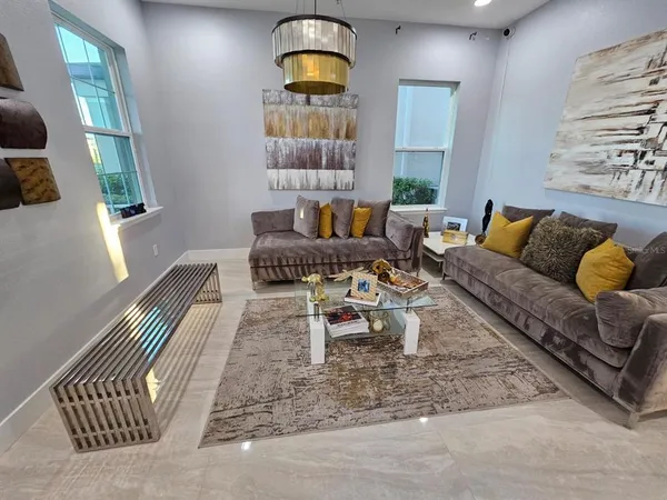 a living room with furniture and a large window