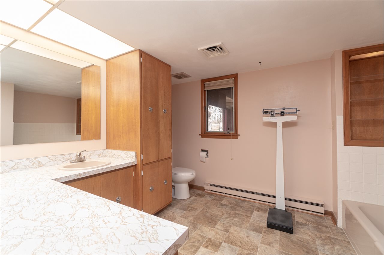 5760 Rotary Road Cherry Valley, IL 61016 - Photo 14 of 25 a bathroom with a sink a toilet and a mirror